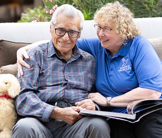 Dementia activities coordinator Gail Higginbotham, CNA, with patient Feliciano Ordonez.